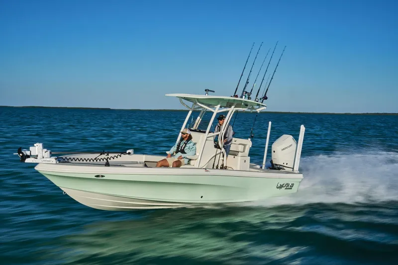 Slide: The Image of 2026 Mako 24 APEX boat with open storage compartment on deck. - 78