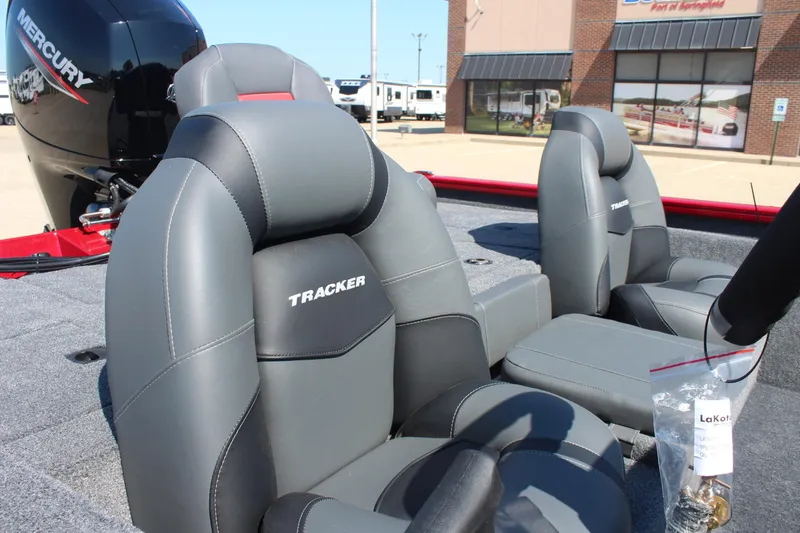 Slide: The Image of 2026 Tracker Pro Team 195 boat seats with Mercury engine in background. - 10