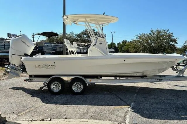 Slide: The Image of 2026 Mako 24 APEX boat on trailer, featuring sleek design and modern amenities. - 1