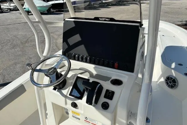 Slide: The Image of 2026 Mako 24 APEX boat console with steering wheel and control panel. - 3