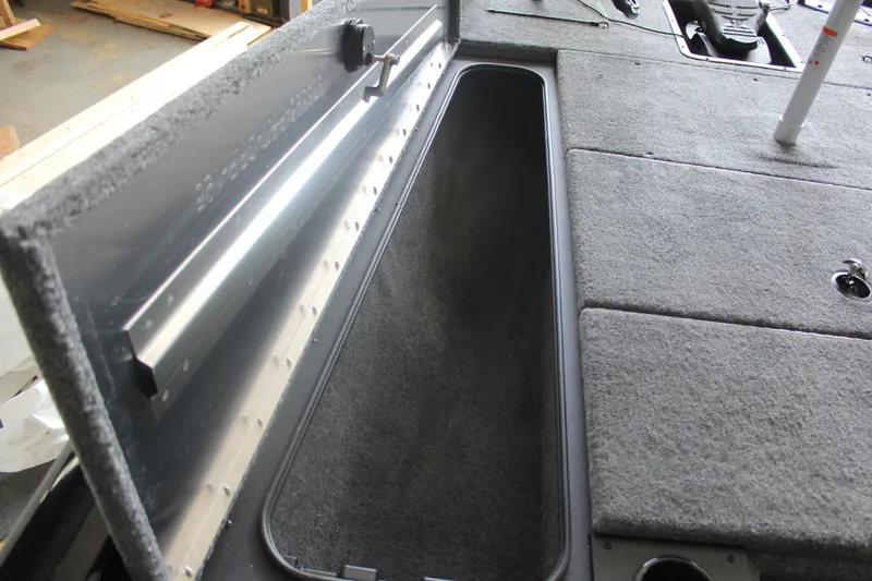 Slide: The Image of 2026 Tracker Pro Team 195 boat storage compartment with open lid, showcasing interior space. - 10