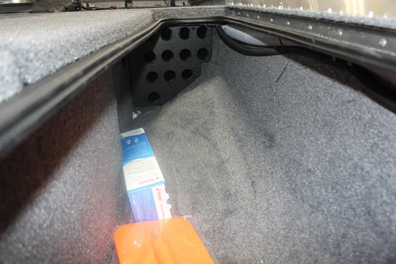 Slide: The Image of Storage compartment of 2026 Tracker Pro Team 195 boat with items inside. - 14