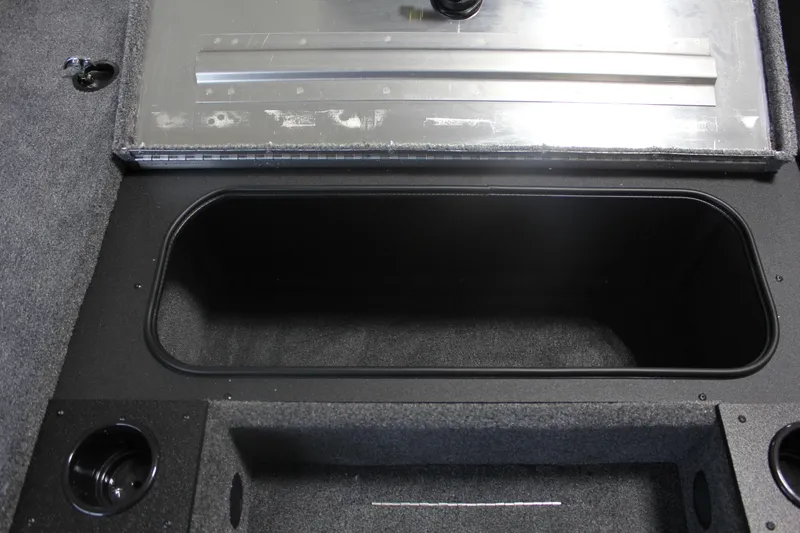 Slide: The Image of 2026 Tracker Pro Team 195 boat storage compartment with carpeted interior and metal lid. - 16