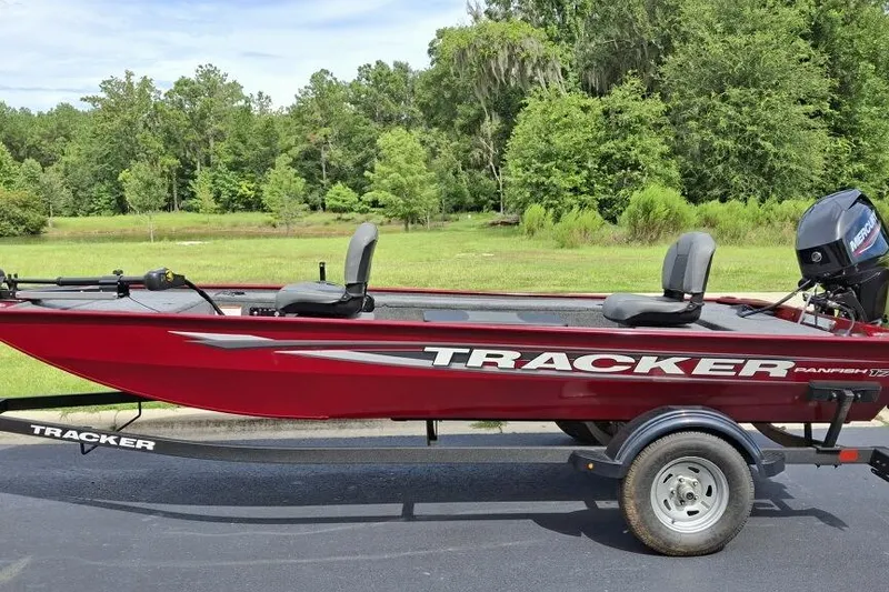 The Image of 2026 Tracker Panfish 17 boat on trailer, red color, parked outdoors. - 0