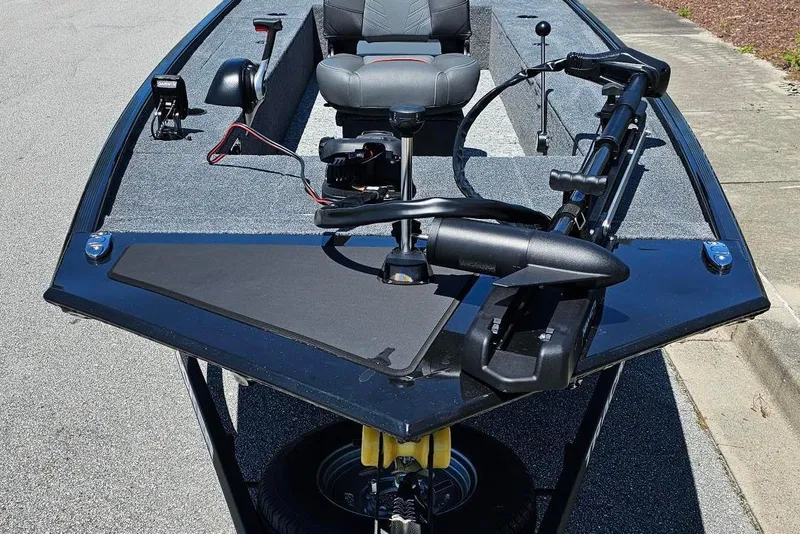 Slide: The Image of 2026 Tracker Panfish 17 boat with trolling motor and seating, parked on a street. - 6