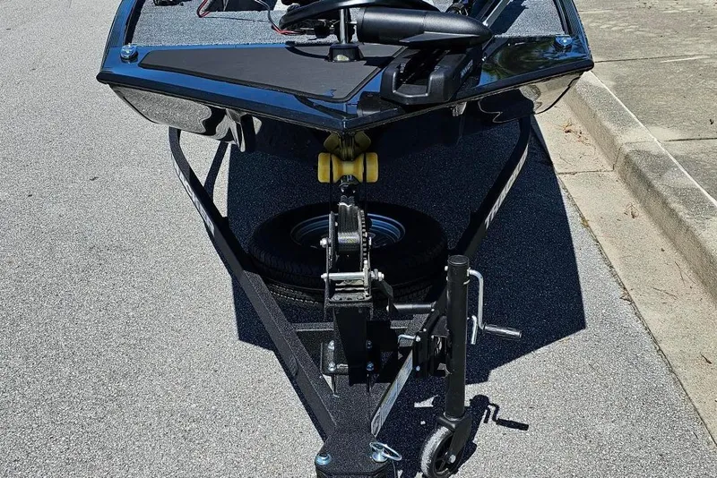 Slide: The Image of 2026 Tracker Panfish 17 boat on trailer, parked on pavement. - 7