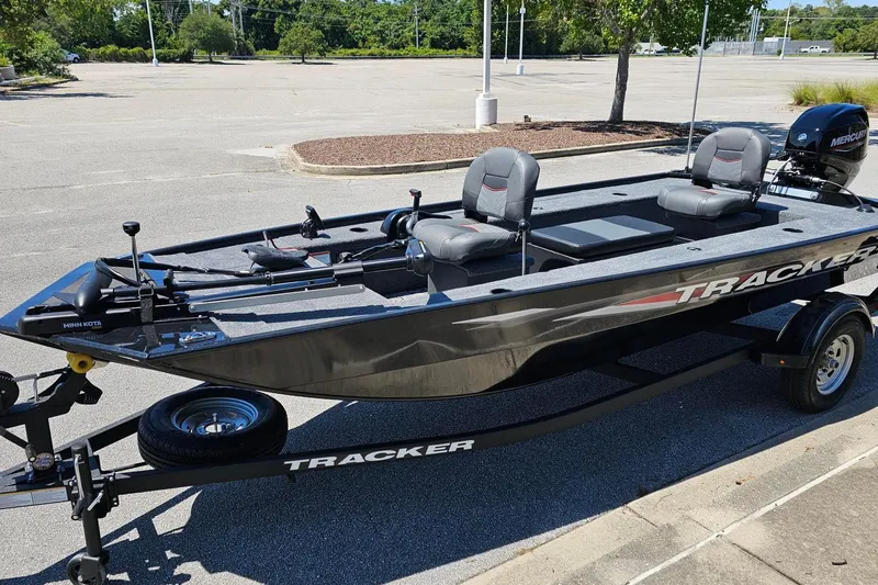 Slide: The Image of 2026 Tracker Panfish 17 boat on trailer in parking lot, featuring dual seats and Mercury motor. - 8
