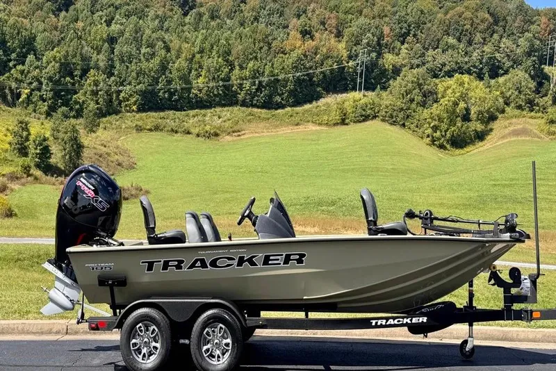Slide: The Image of 2026 Tracker Pro Team 195 boat on trailer, set against a scenic green landscape. - 2