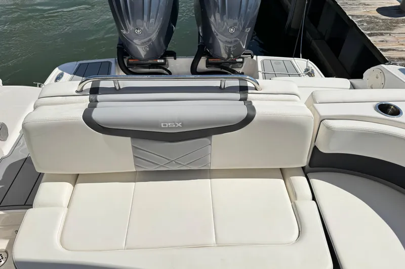 Slide: The Image of 2022 Chaparral 280 OSX boat with white seating and dual outboard engines. - 10