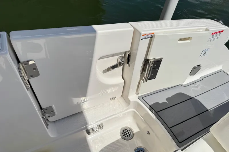 Slide: The Image of 2022 Chaparral 280 OSX boat deck with open hatch and stainless steel hardware. - 12