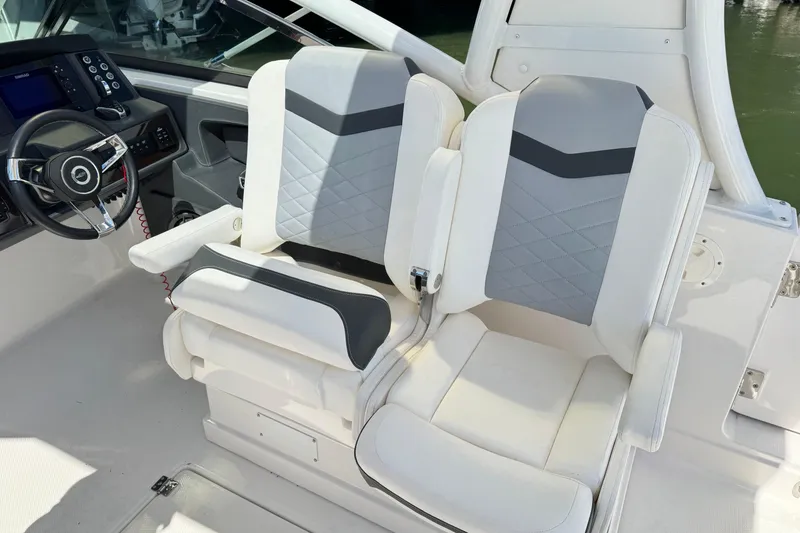 Slide: The Image of 2022 Chaparral 280 OSX boat interior with dual seats and steering console. - 18