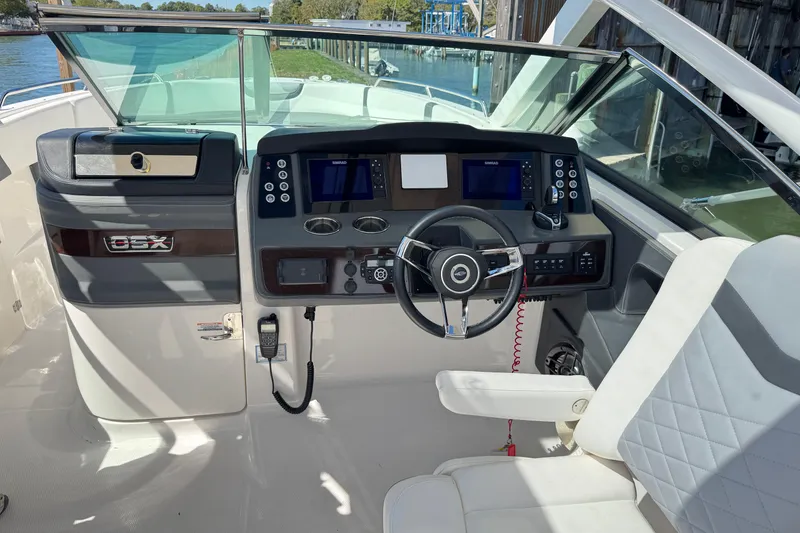 Slide: The Image of 2022 Chaparral 280 OSX boat cockpit with modern steering and navigation controls. - 19