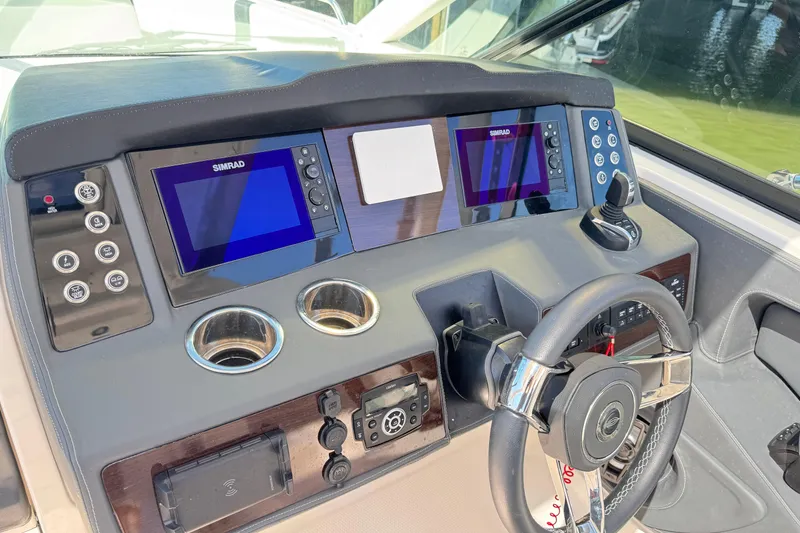 Slide: The Image of 2022 Chaparral 280 OSX helm with dual Simrad displays and modern controls. - 20