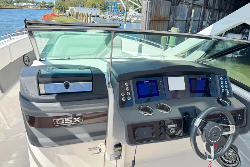 Slide: The Image of 2022 Chaparral 280 OSX boat dashboard with dual screens and steering wheel. - 21