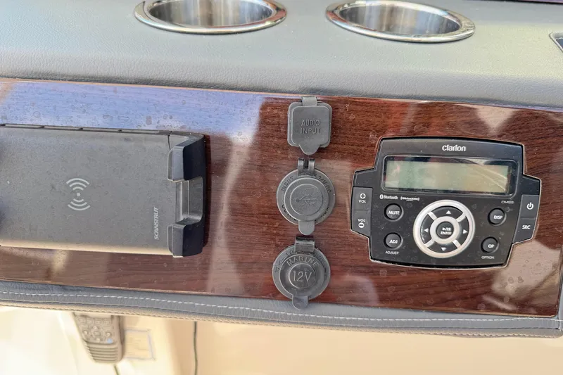 Slide: The Image of Dashboard of 2022 Chaparral 280 OSX with audio system and charging ports. - 23