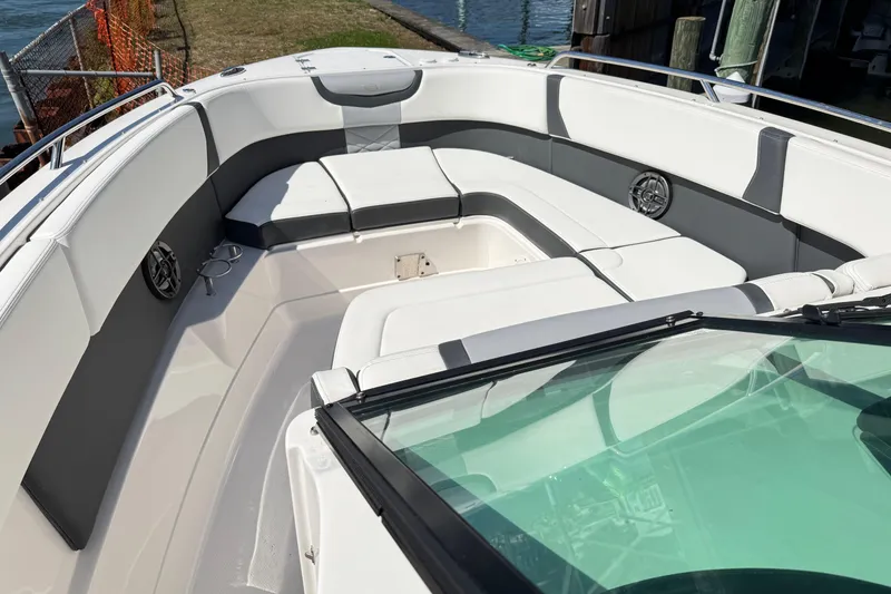 Slide: The Image of 2022 Chaparral 280 OSX boat interior with white seating and speakers. - 29