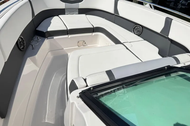 Slide: The Image of 2022 Chaparral 280 OSX boat interior with cushioned seating and speakers. - 30