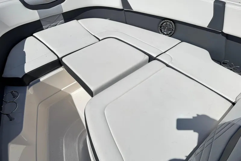 Slide: The Image of 2022 Chaparral 280 OSX boat interior with cushioned seating and cup holders. - 31