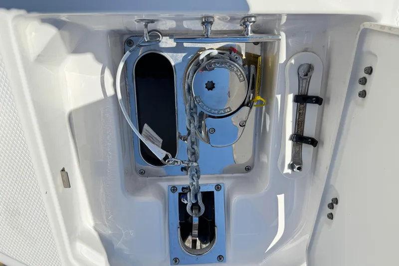 Slide: The Image of Anchor compartment of 2022 Chaparral 280 OSX boat with chain and wrench. - 33
