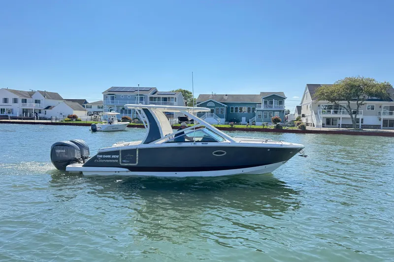 Slide: The Image of 2022 Chaparral 280 OSX boat cruising on a sunny day near waterfront homes. - 44