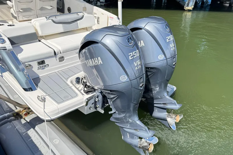 Slide: The Image of 2022 Chaparral 280 OSX boat with dual Yamaha 250 V6 engines on water. - 6
