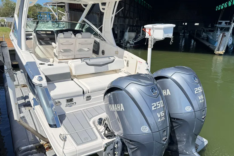 Slide: The Image of 2022 Chaparral 280 OSX boat with dual Yamaha 250 V6 engines docked in marina. - 7