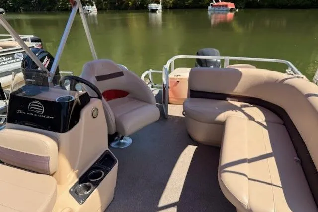 Slide: The Image of 2017 Sun Tracker Bass Buggy 18 DLX pontoon boat with beige seating on a calm lake. - 5