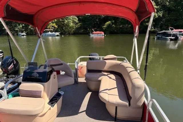 Slide: The Image of 2017 Sun Tracker Bass Buggy 18 DLX pontoon boat with red canopy on a calm lake. - 8