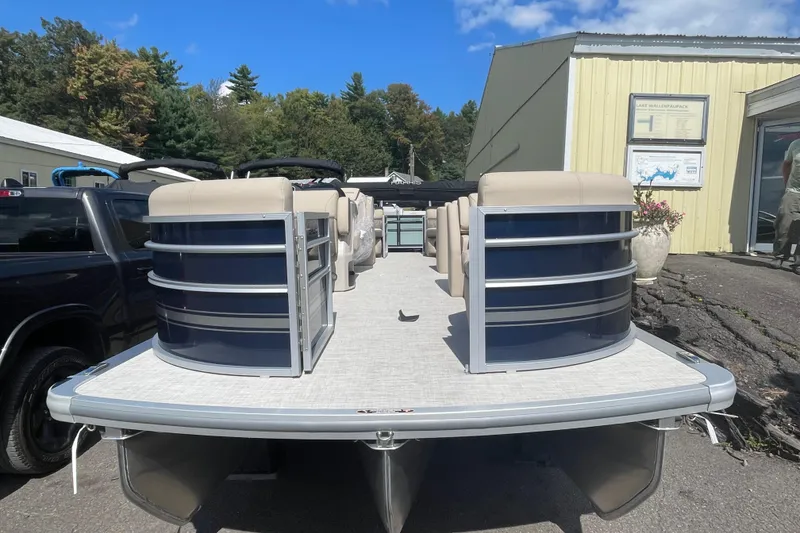 The Image of 2026 Harris Cruiser 230 CW pontoon boat parked outdoors near a building. - 1