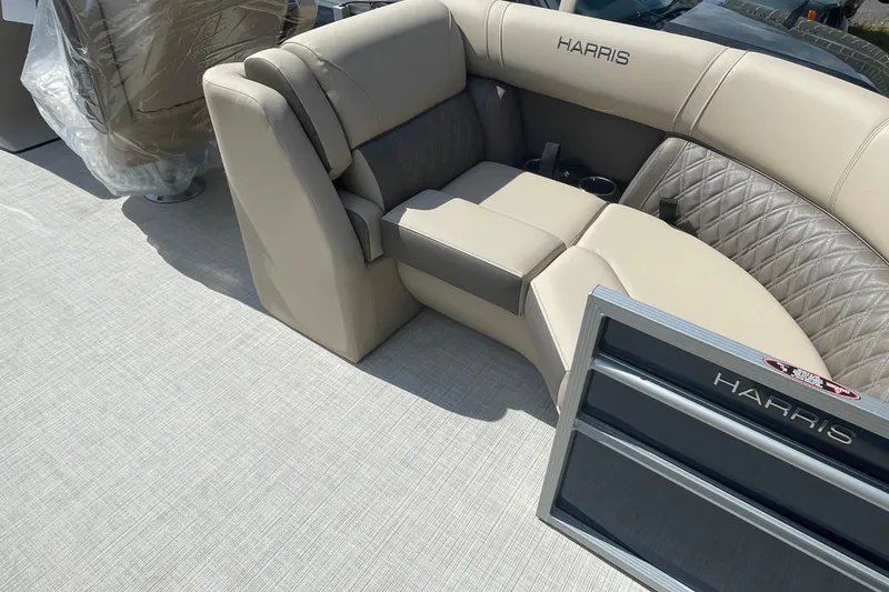 Slide: The Image of 2026 Harris Cruiser 230 CW boat interior with beige seating and quilted accents. - 10
