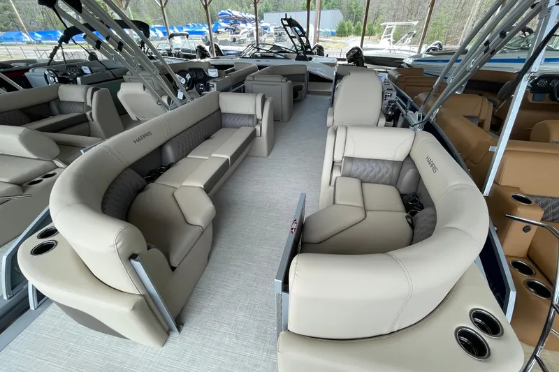 Slide: The Image of Luxurious interior of 2026 Harris Cruiser 230 pontoon boat with plush seating and cup holders. - 16