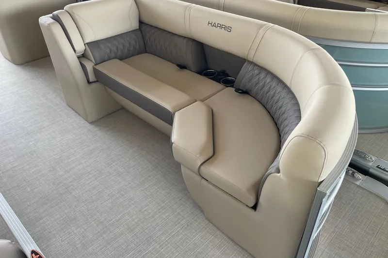 Slide: The Image of 2026 Harris Cruiser 230 boat interior with beige seating and cup holders. - 21