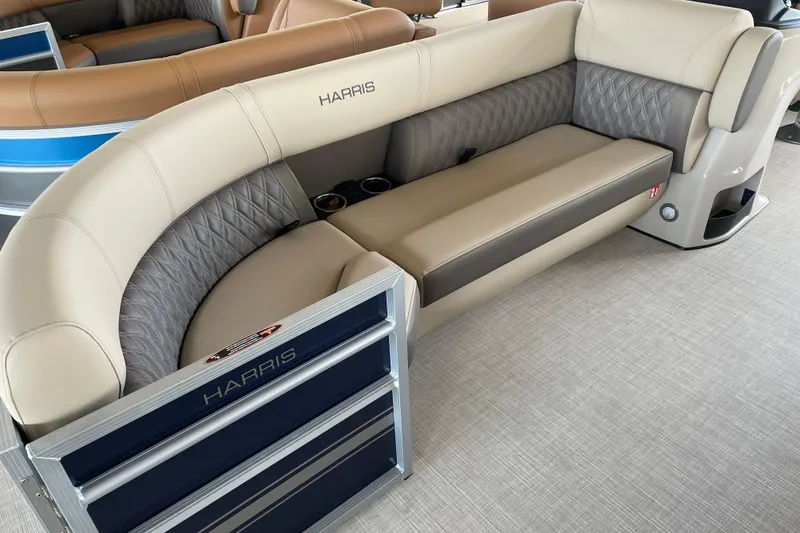 Slide: The Image of 2026 Harris Cruiser 230 pontoon boat interior with beige seating and cup holders. - 22