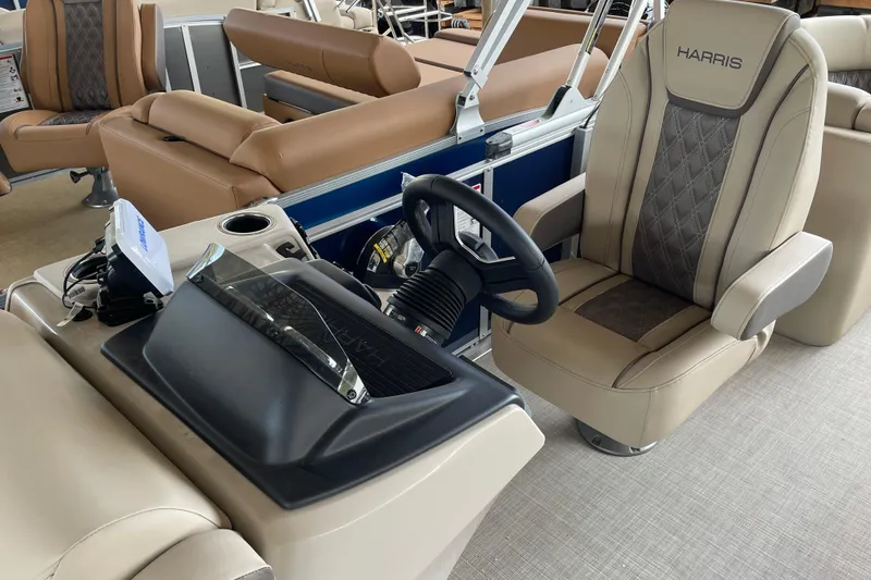 Slide: The Image of 2026 Harris Cruiser 230 boat interior with luxurious seating and modern steering console. - 24
