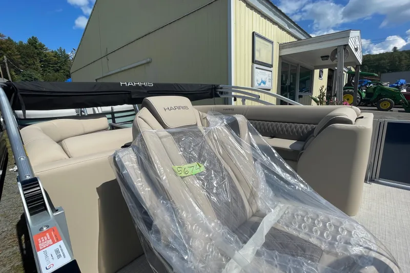 Slide: The Image of 2026 Harris Cruiser 230 CW pontoon boat with beige seating, displayed outdoors. - 6