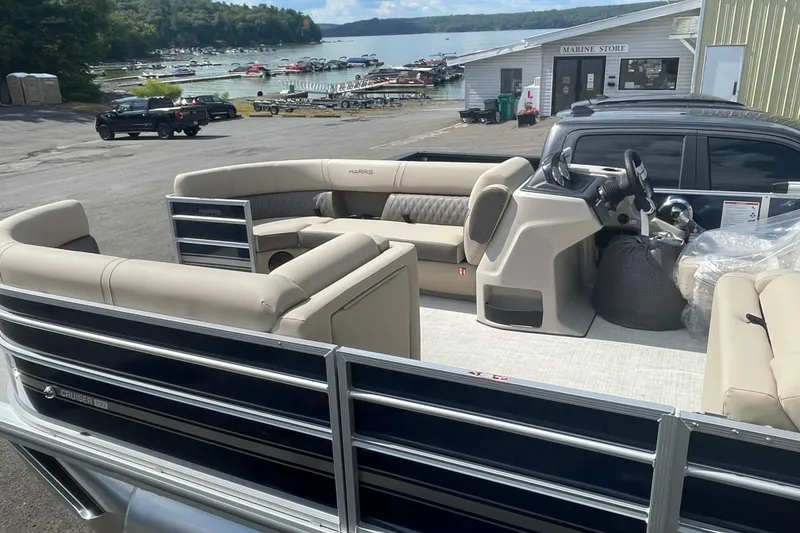 Slide: The Image of 2026 Harris Cruiser 230 CW pontoon boat at marina, featuring spacious seating and modern design. - 9