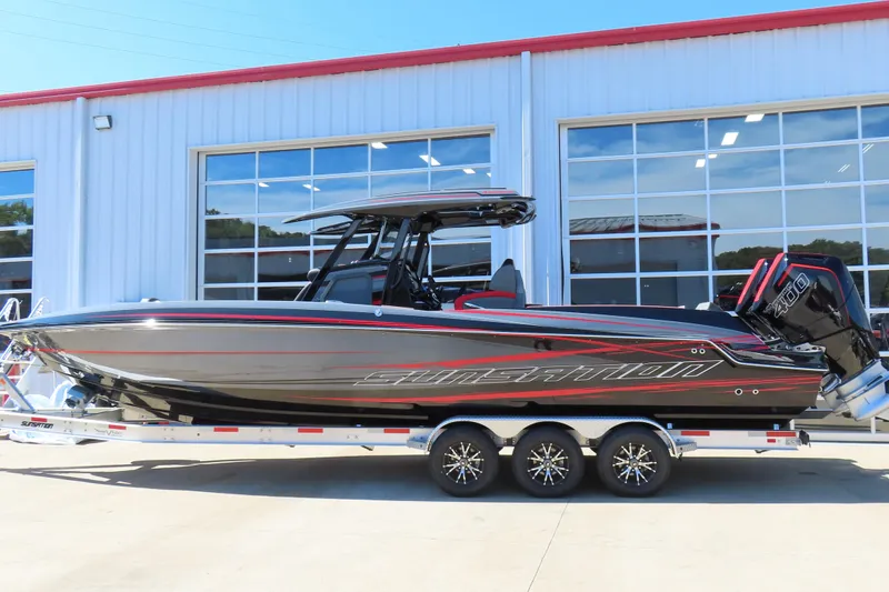 Slide: The Image of 2026 Sunsation 32CCX boat with sleek design and powerful engines on a trailer. - 1