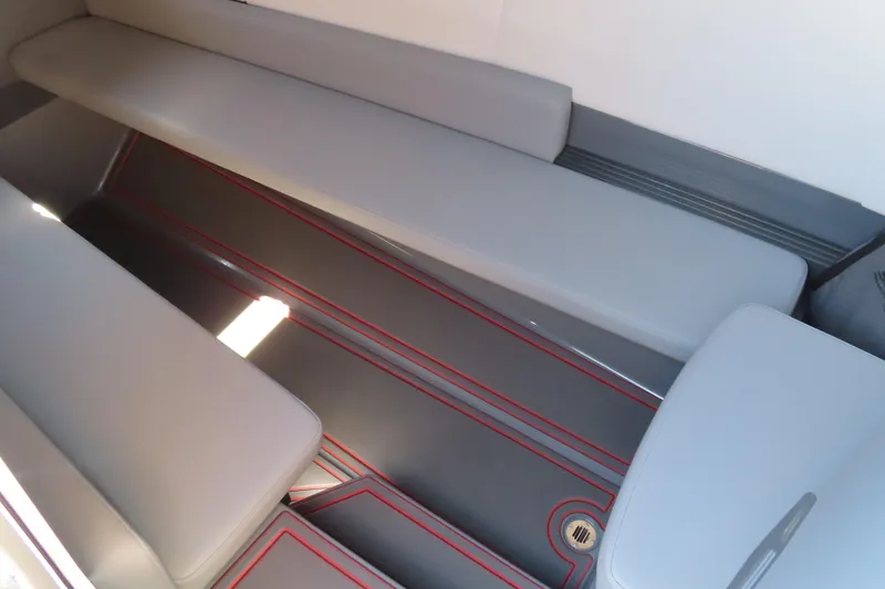 Slide: The Image of 2026 Sunsation 32CCX interior with sleek gray seating and red accents. - 13