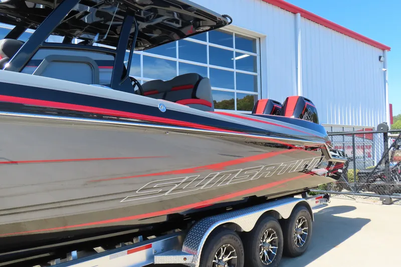 Slide: The Image of 2026 Sunsation 32CCX boat with sleek design and triple-axle trailer. - 4
