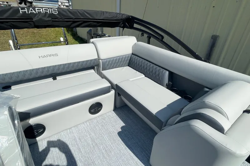 Slide: The Image of 2026 Harris Cruiser 210 SL boat interior with luxurious gray seating and cup holders. - 4