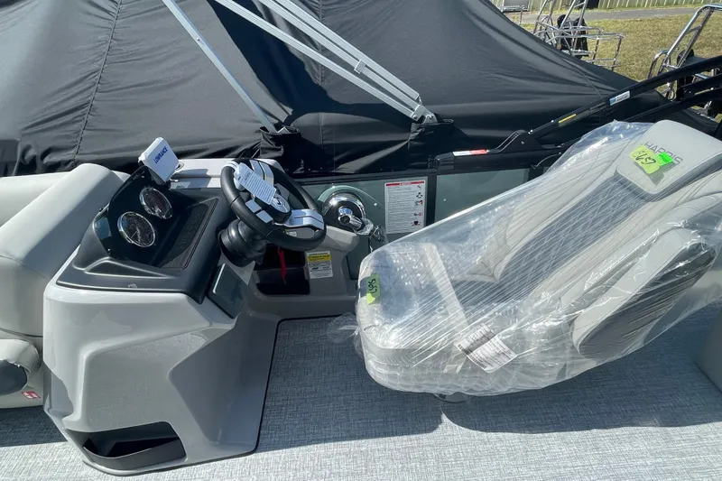 Slide: The Image of 2026 Harris Cruiser 210 SL boat interior with steering wheel and wrapped captain's chair. - 5