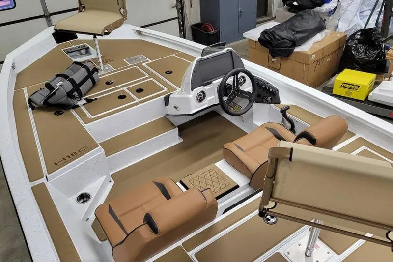 Slide: The Image of 2026 Xpress H18 Bass boat interior with tan seating and modern dashboard. - 3