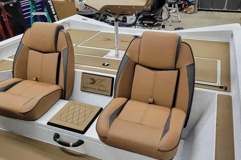 Slide: The Image of 2026 Xpress H18 Bass boat interior with tan leather seats and branded details. - 4