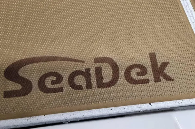 Slide: The Image of SeaDek logo on textured surface of 2026 Xpress H18 Bass boat. - 5