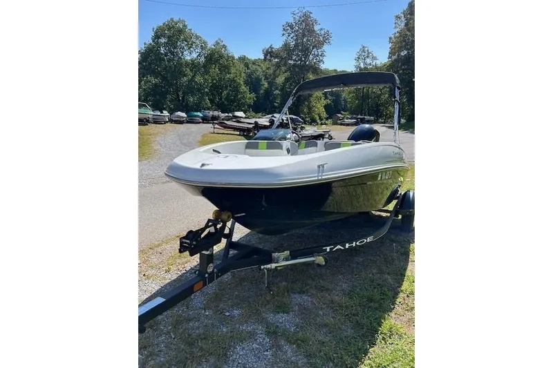 Slide: The Image of 2021 Tahoe T16 boat on trailer, parked outdoors on a sunny day. - 3