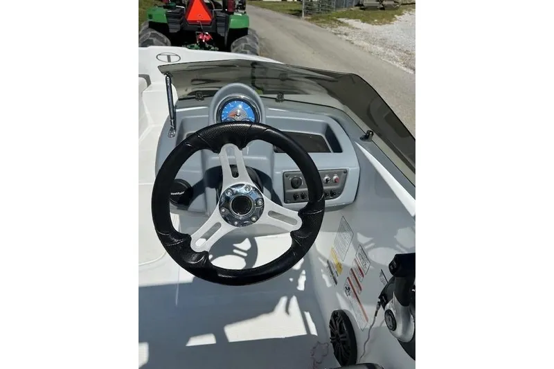 Slide: The Image of 2021 Tahoe T16 boat dashboard with steering wheel and control panel. - 6