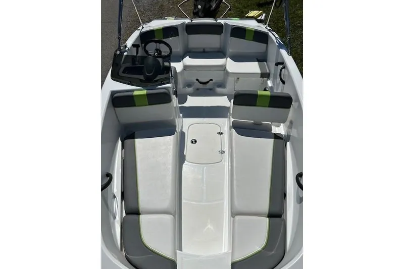 Slide: The Image of 2021 Tahoe T16 boat interior with gray and green seating, steering console, and spacious layout. - 8