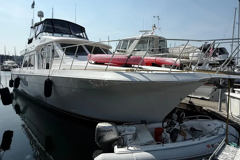 Slide: The Image of 2003 Navigator 53 yacht docked at marina with inflatable boat and kayak on deck. - 1
