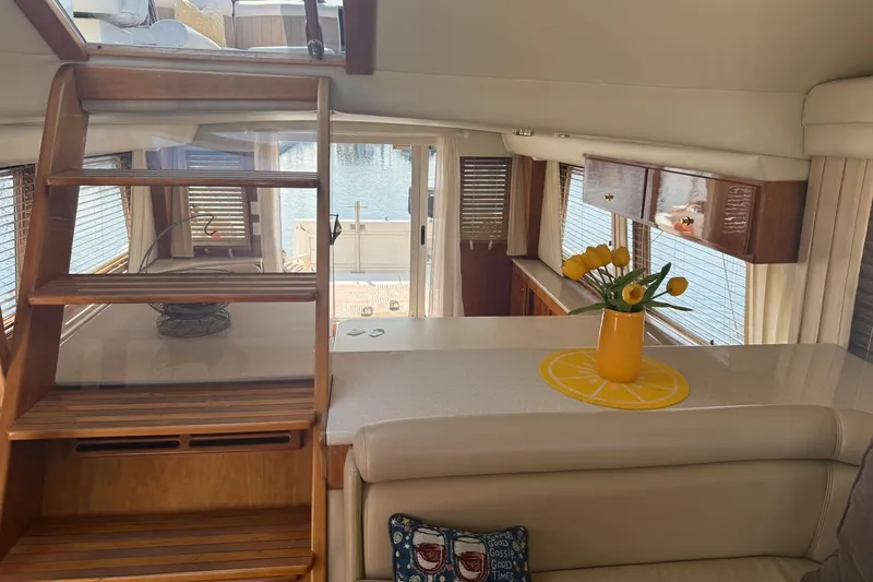 Slide: The Image of Interior of 2003 Navigator 53 yacht with wooden stairs and yellow flowers in a vase. - 4