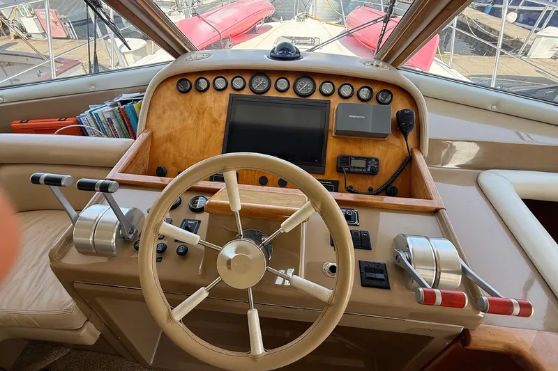 Slide: The Image of 2003 Navigator 53 yacht helm with steering wheel, controls, and navigation equipment. - 5